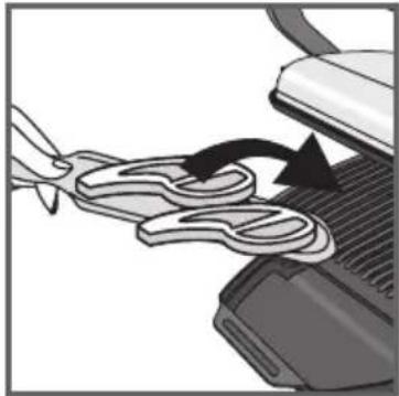 Close-up of a mechanical component with a hand holding a piece of dough and a curved arrow indicating rotation (no text or symbols)