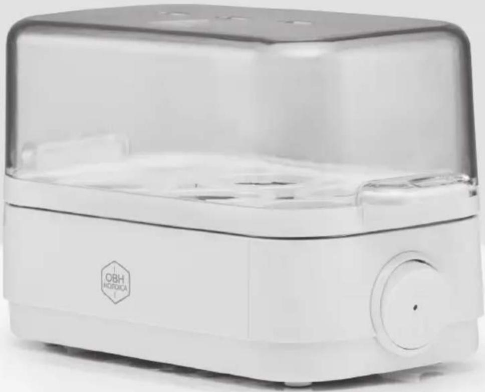 Exterior view of a modern white portable food appliance with a transparent lid and circular vent (no visible text or symbols)