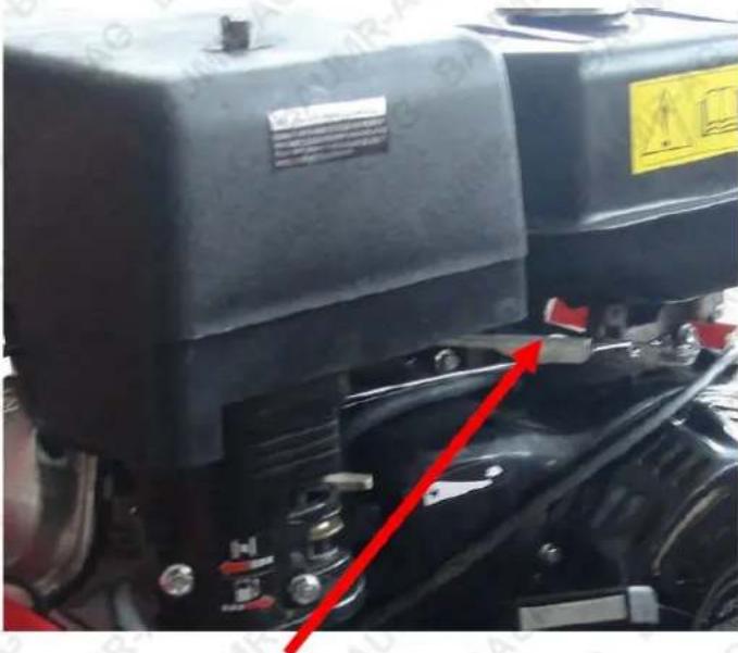 Close-up of a mechanical device with visible warning labels and red directional arrows indicating movement or force.