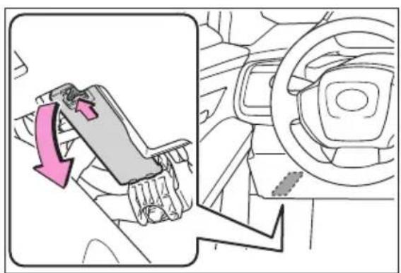 Diagram showing car seatbelt mechanism with pink directional arrow indicating rotation or movement