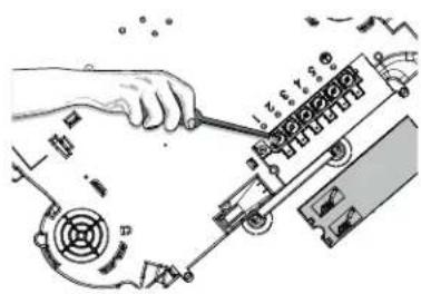 Technical diagram showing a hand using a tool to adjust or install electronic components with visible labels and directional arrows.