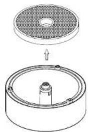 Technical diagram showing a circular component with a perforated top and a cylindrical base with a central rod (no text or symbols)