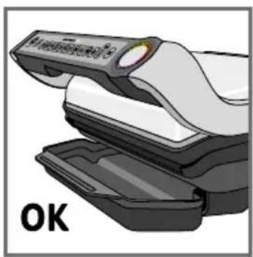 Illustration of a medical device with open lid and black casing, labeled 'OK' (no text or symbols on the device itself)