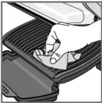 Close-up of a hand pressing down on a textured surface with a tool (no text or symbols visible)