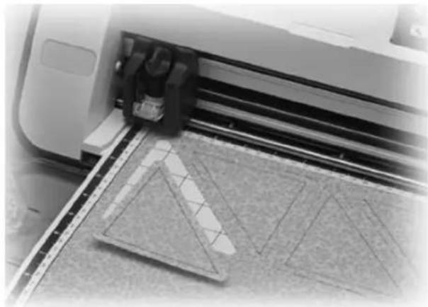 Close-up of a 3D printer printing or printing process with a grid-patterned surface (no visible text or symbols)