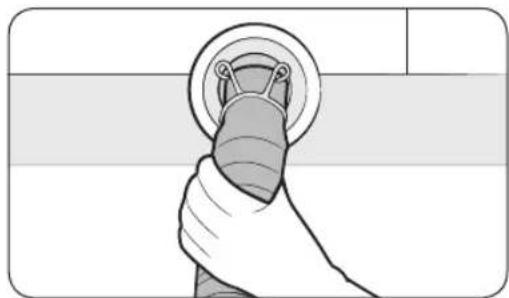 Illustration of a hand holding a circular object with a ring, against a plain background (no text or symbols)