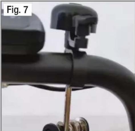 Close-up of a black bicycle handle with metal clamps and a metallic bracket (no text or symbols visible)