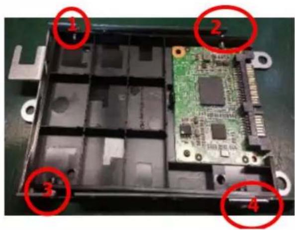 Labeled photo of an electronic device casing with numbered components, showing internal circuitry and mounting holes.