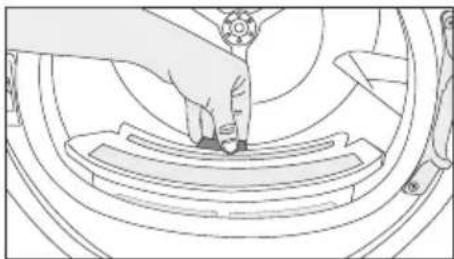Line drawing of a hand pressing down on a mechanical component (no text or symbols)