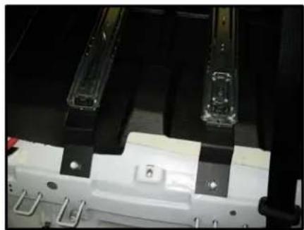 Close-up of a mechanical assembly with transparent components and mounting brackets (no visible text or symbols)