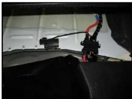 Close-up of a car interior showing wiring and connectors (no visible text or symbols)
