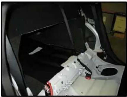 Interior view of a car showing the hood, seat, and internal components (no visible text or symbols)