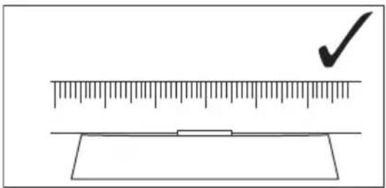 Diagram showing a ruler measuring a rectangular object with a checkmark indicating the measurement.