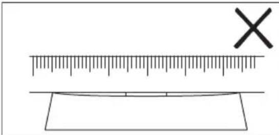 Diagram showing a ruler and a rectangular object with an 'X' mark, likely illustrating measurement or calibration concepts.