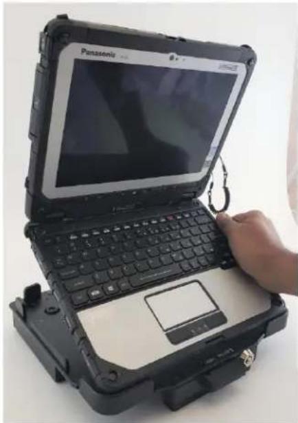 Hand holding a Panasonic hard disk laptop with visible screen and keyboard (no text or symbols on device)