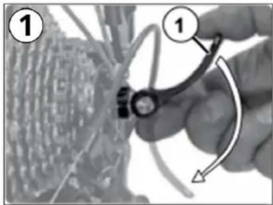 Instructional diagram showing a hand holding a mechanical component with labeled parts and an arrow indicating rotation or adjustment.
