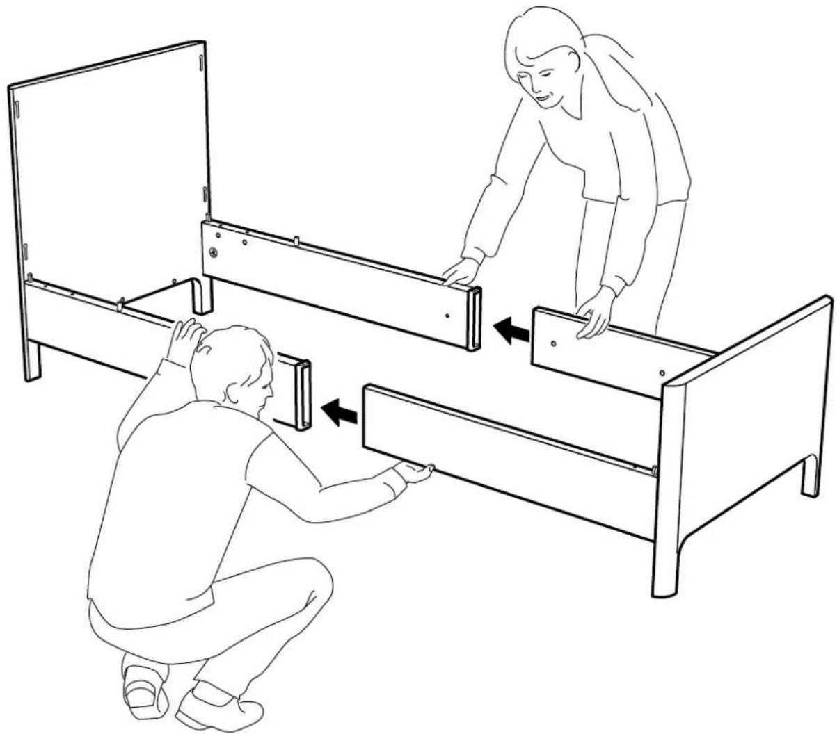 Line drawing showing two people installing or adjusting a wooden bed frame, with one person kneeling and the other leaning forward (no text or symbols present)