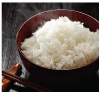 Close-up of a bowl filled with shredded white food, placed on a dark wooden surface (no text or symbols visible)