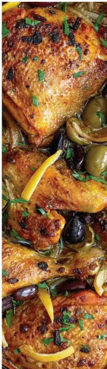 Close-up of a cooked chicken dish with olive, black beans, and garnishes (no visible text or symbols)