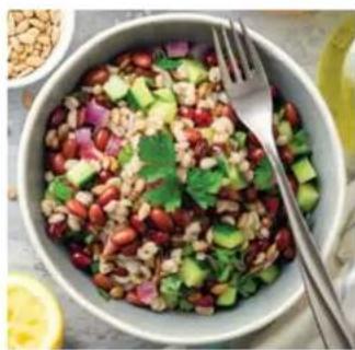 Close-up of a colorful salad in a bowl with fork and spoon, no visible text or symbols