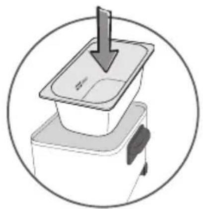 Diagram of a device with a downward arrow pointing to a lid, enclosed in a circle (no text or symbols)