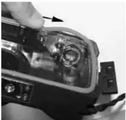 Close-up of a hand using a tool to adjust internal components, no visible text or symbols