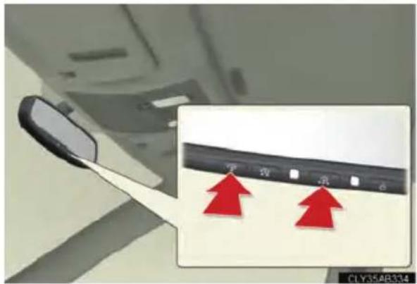 Car interior panel with red directional arrows pointing to specific components, one pointing downward