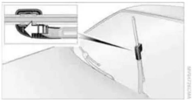 Technical illustration of a mechanical component with an inset showing a close-up view of a tool interacting with a bracket (no text or symbols present)
