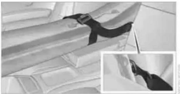 Close-up of a fabric or metal object with a black strap, shown in grayscale (no text or symbols visible)