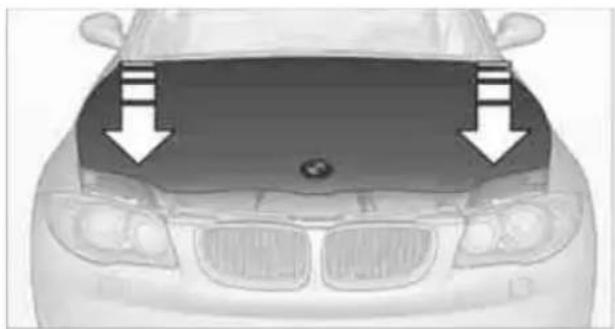 Front view of a car with a hood and arrow indicators (no text or symbols)
