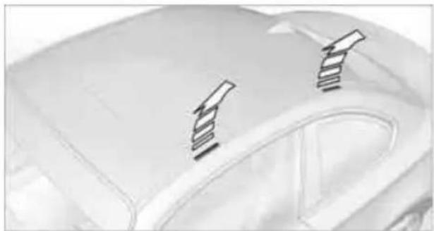 Close-up of a car's roof with two mounted rectangular components on the side (no visible text or symbols)