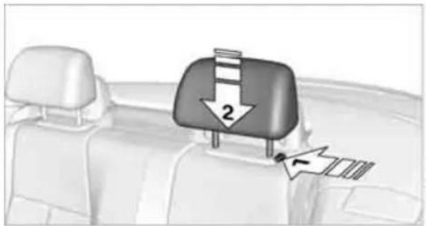 Interior view of a car showing a seatbelt with a downward arrow and a small inset image (no text or symbols)