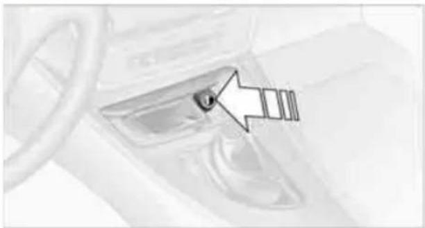 Close-up of a car interior with a highlighted glass door and arrow pointing to a small object (no text or symbols visible)