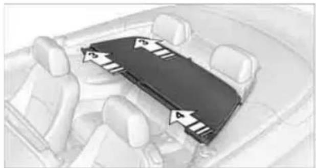 Interior view of a car showing the rear wheel, dashboard, and seat area with directional arrows indicating movement (no text or symbols)