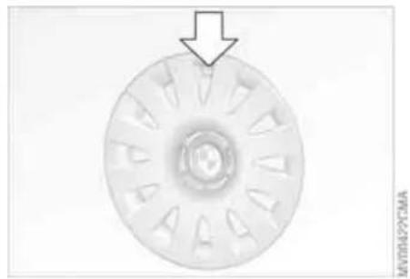 Circular mechanical component with radial slots and a central hub, marked with an arrow pointing downward (no text or symbols)