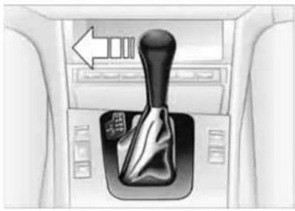 Interior view of a car gear shift lever with directional arrow (no text or symbols)
