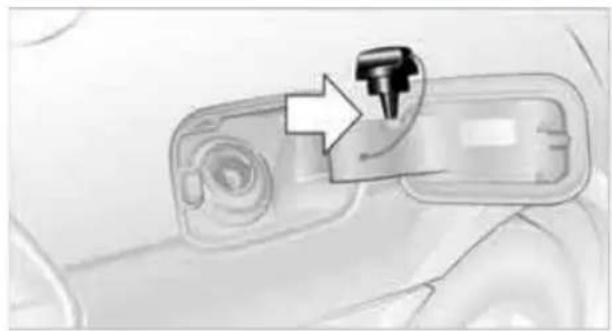 Close-up of a car interior panel with a black tool icon pointing to a button (no text or symbols visible)