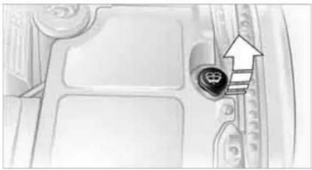 Close-up of a car interior with a highlighted key and an arrow pointing to a staircase (no text or symbols visible)