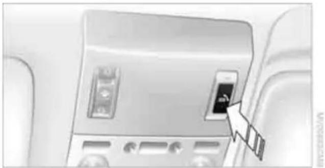 Interior view of a vehicle air conditioner unit with a hand pointing to the back panel (no visible text or symbols)