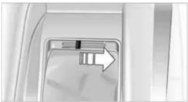 Close-up of a car interior showing a directional arrow pointing to a component (no text or symbols visible)