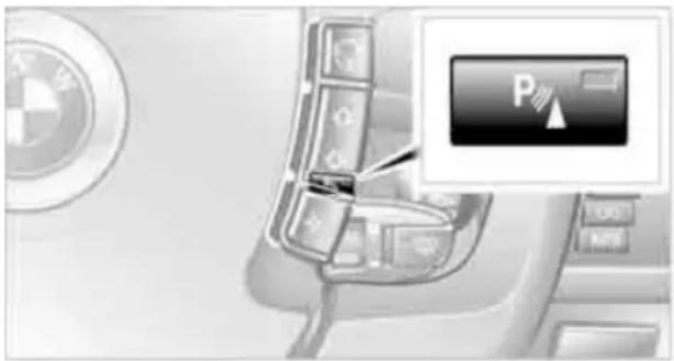 Interior view of a car with a BMW logo and a parking control panel (no readable text or symbols)