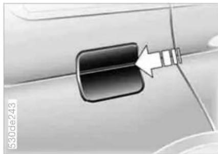 Close-up of a car door handle with a white arrow pointing to a component, no visible text or symbols