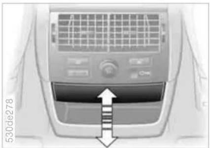 Interior view of a car air conditioner unit with airflow direction indicator (no text or symbols)