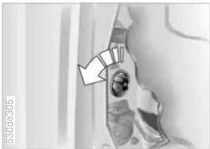 Medical scan image showing a cross-sectional view of a vehicle with an arrow pointing to a specific area (no text or symbols present)