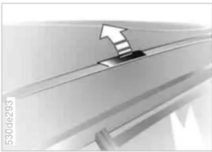 Close-up of a car's roof edge with an arrow indicating upward motion (no text or symbols)