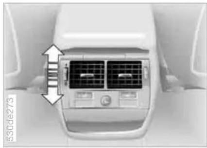 Top-down view of a white car air conditioner unit with ventilation grilles and control buttons (no visible text or symbols)