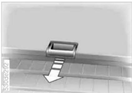 Close-up of a metallic mechanical component with a downward arrow, placed on a grid-patterned surface (no text or symbols visible)