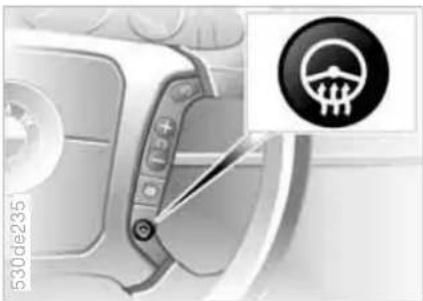 Close-up of a car gear shift lever with a warning symbol (no text or labels visible)