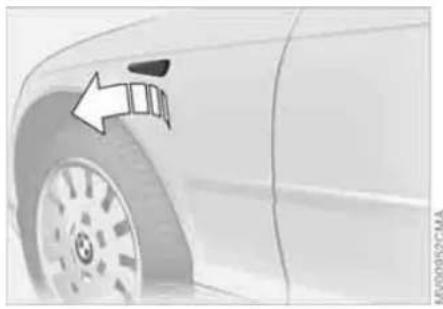 Close-up of a car tire with an arrow pointing to the wheel (no text or symbols visible)