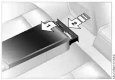 Close-up of a mechanical component with directional arrows and a small inset showing a magnified view (no text or symbols)
